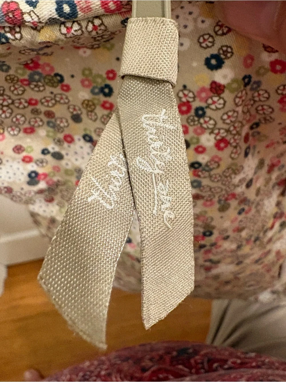Thirty-One floral laptop sleeve features a floral pattern on a cream background